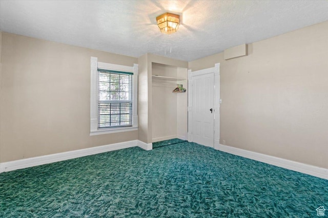 unfurnished bedroom featuring carpet flooring, baseboards, a closet, and a textured ceiling