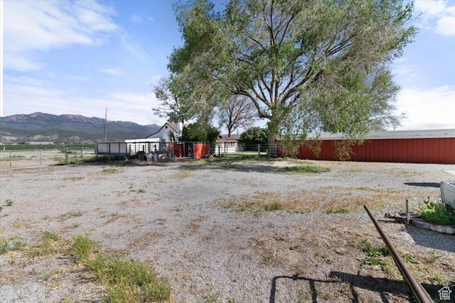 view of yard with a mountain view and fence