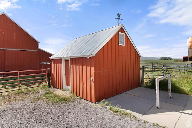 view of barn featuring fence