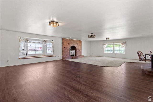 unfurnished living room featuring wood finished floors and a fireplace