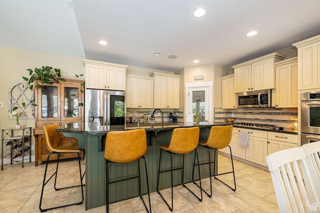 1608 W Boulder Creek Ln S, Layton, UT 84041 - kitchen featuring appliances with stainless steel finishes, cream cabinets, tasteful backsplash, light tile patterned flooring, and recessed lighting