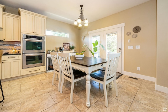 1608 W Boulder Creek Ln S, Layton, UT 84041 - dining area featuring light tile patterned flooring, baseboards, and a chandelier