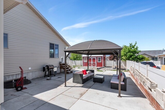 2177 N 130 W, Tooele, UT 84074 - view of patio / terrace with an outdoor living space, a shed, area for grilling, a fenced backyard, and an outbuilding