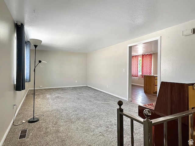 45 W 200 N, Castle Dale, UT 84513 - unfurnished living room with carpet flooring, baseboards, and a textured ceiling
