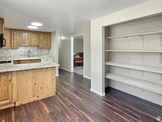 45 W 200 N, Castle Dale, UT 84513 - kitchen featuring black microwave, light stone countertops, dark wood-style floors, baseboards, and backsplash