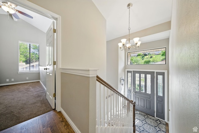 entryway featuring a chandelier, high vaulted ceiling, wood finished floors, a ceiling fan, and baseboards