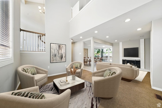 carpeted living room with a chandelier, baseboards, and recessed lighting