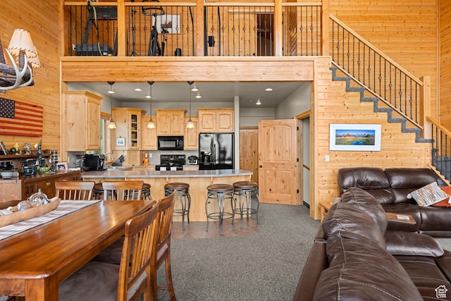 866 N Yarrow Cir Unit 38/39, Garden City, UT 84028 - living room with wood walls, a high ceiling, and stairs