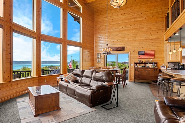 866 N Yarrow Cir Unit 38/39, Garden City, UT 84028 - living room featuring a high ceiling, wooden walls, a chandelier, and carpet
