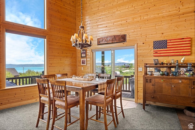 866 N Yarrow Cir Unit 38/39, Garden City, UT 84028 - dining space with wooden walls, a chandelier, plenty of natural light, a water view, and a towering ceiling
