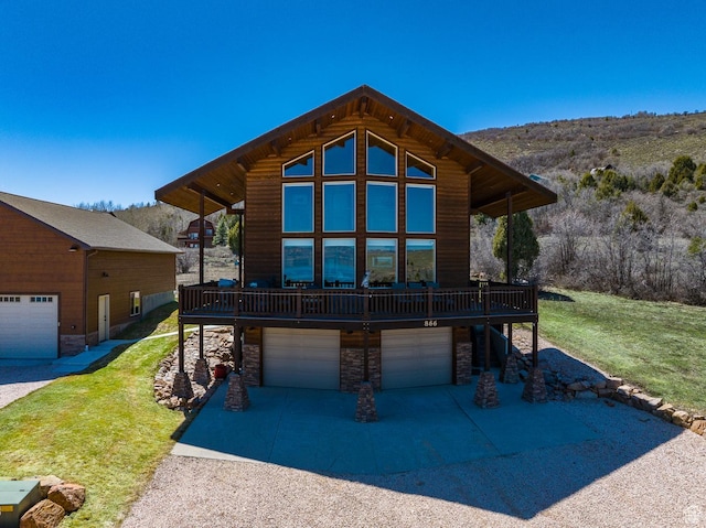 866 N Yarrow Cir Unit 38/39, Garden City, UT 84028 - view of front of house with stone siding, a front yard, a garage, and a deck