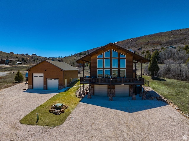866 N Yarrow Cir Unit 38/39, Garden City, UT 84028 - view of front of property with stone siding, a front yard, a deck, and a detached garage