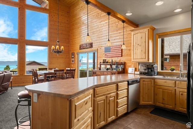 866 N Yarrow Cir Unit 38/39, Garden City, UT 84028 - kitchen featuring stainless steel dishwasher, high vaulted ceiling, a peninsula, wood walls, and a chandelier