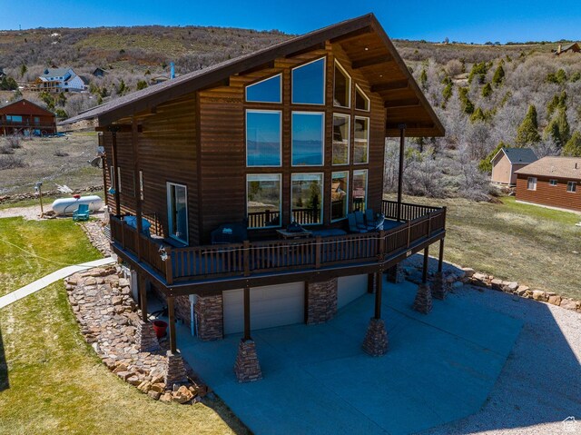 866 N Yarrow Cir Unit 38/39, Garden City, UT 84028 - rear view of property featuring a wooden deck, stone siding, and a garage