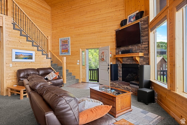 866 N Yarrow Cir Unit 38/39, Garden City, UT 84028 - living area with wood walls, stairway, a towering ceiling, a stone fireplace, and carpet