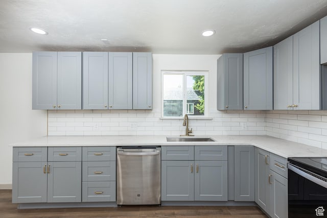 kitchen with stainless steel dishwasher, a sink, dark wood-style floors, gray cabinets, and black electric range
