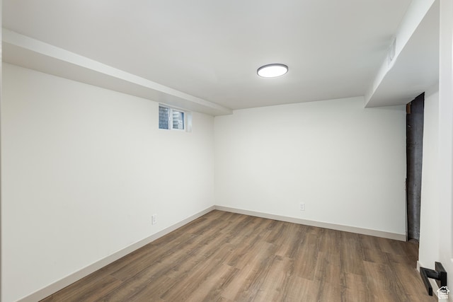 below grade area with wood finished floors and baseboards