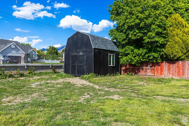 view of yard featuring a storage shed and an outbuilding