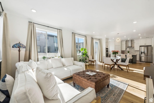 living room with light wood finished floors and recessed lighting