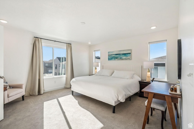 bedroom with light carpet and recessed lighting