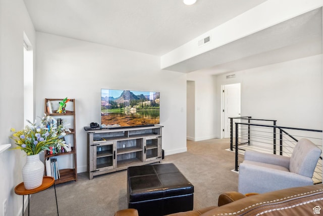 carpeted living area with baseboards