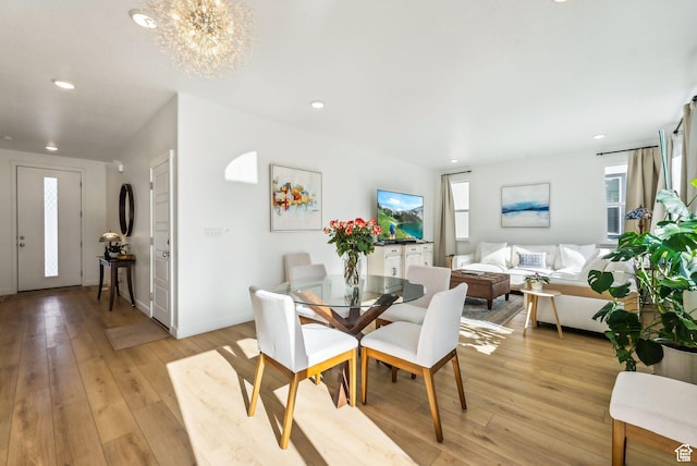 dining area featuring light wood-type flooring, a chandelier, recessed lighting, and baseboards