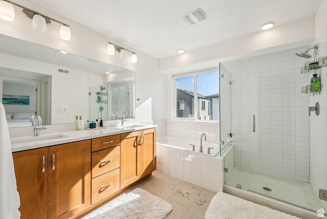 bathroom featuring a garden tub, a stall shower, double vanity, and tile patterned flooring