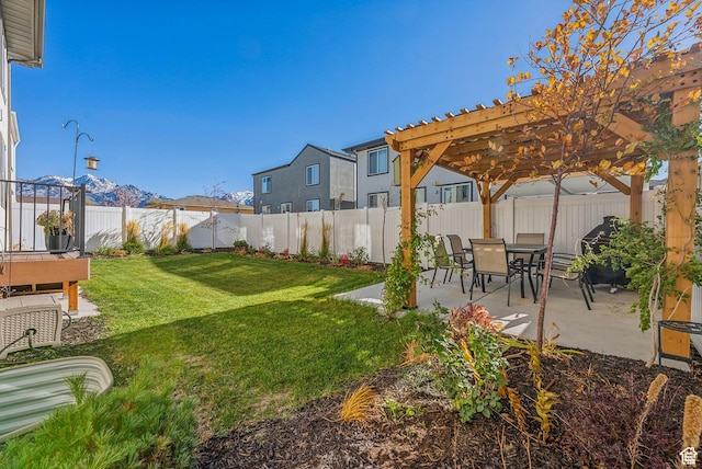 view of yard featuring a pergola, a patio, and a mountain view