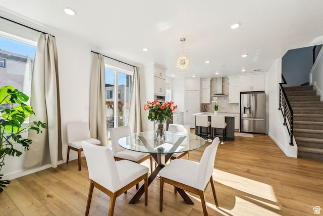dining area featuring stairway, healthy amount of natural light, light wood-type flooring, recessed lighting, and baseboards