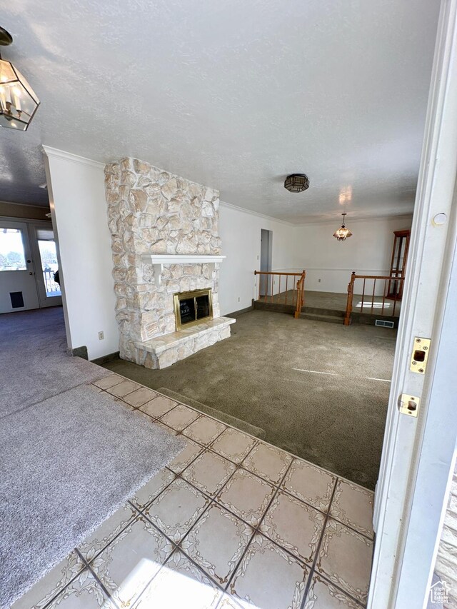 40 W 200 N, Santaquin, UT 84655 - unfurnished living room featuring carpet flooring, crown molding, a chandelier, baseboards, and a fireplace