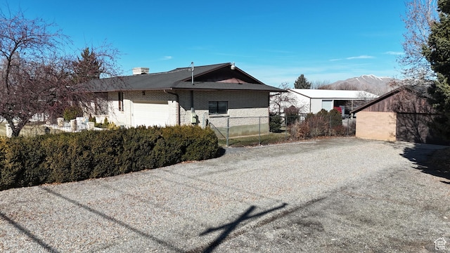 40 W 200 N, Santaquin, UT 84655 - view of front facade with brick siding, fence, an attached garage, and a mountain view