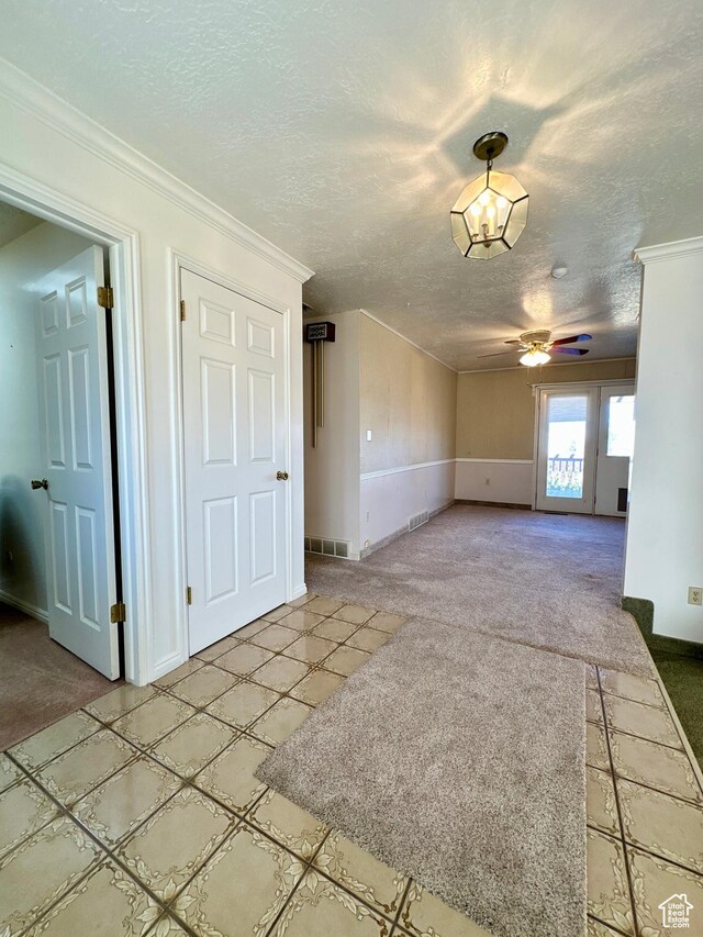 40 W 200 N, Santaquin, UT 84655 - unfurnished living room with light colored carpet, a textured ceiling, a ceiling fan, and crown molding