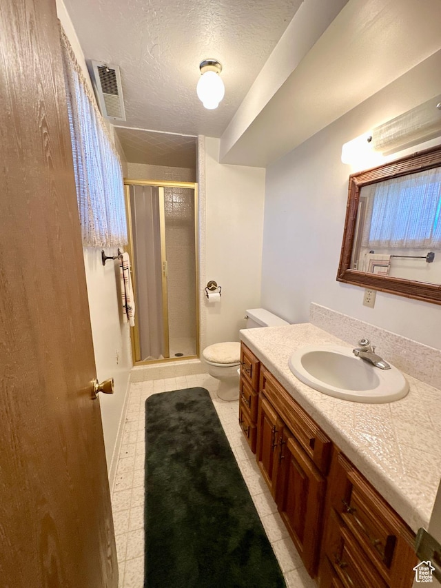 40 W 200 N, Santaquin, UT 84655 - bathroom featuring a stall shower, vanity, toilet, a textured ceiling, and tile patterned floors