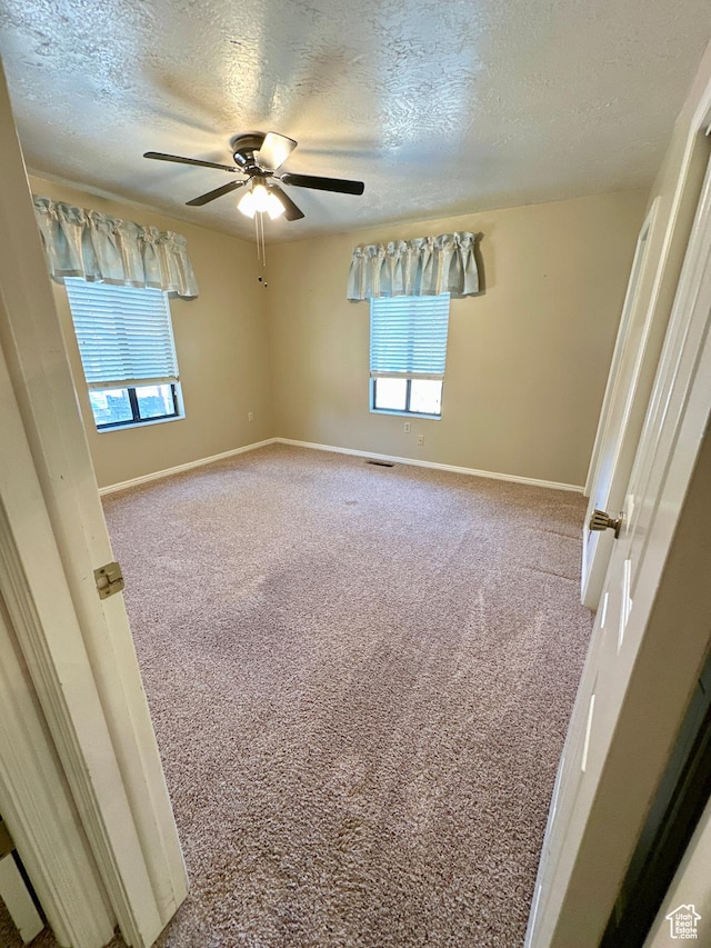 40 W 200 N, Santaquin, UT 84655 - empty room featuring carpet flooring, a textured ceiling, a ceiling fan, and baseboards