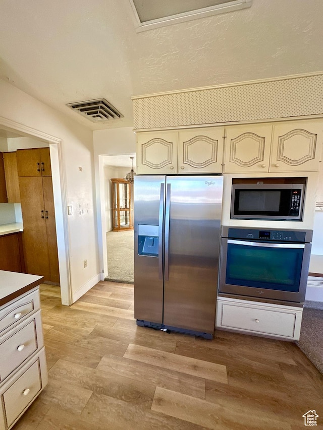 40 W 200 N, Santaquin, UT 84655 - kitchen featuring stainless steel appliances, cream cabinets, light wood-style floors, light countertops, and baseboards
