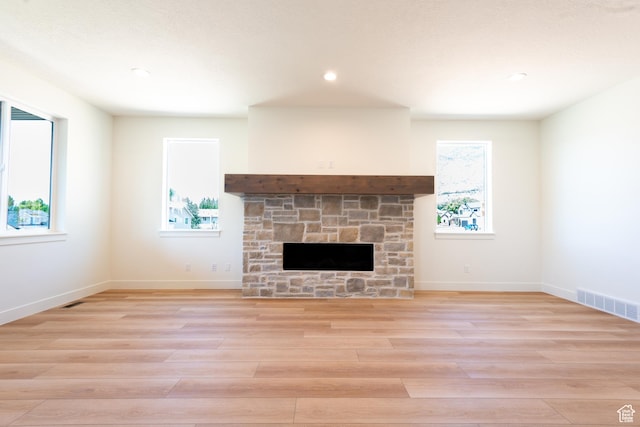 1699 N Siena Cir Unit 5, Pleasant Grove, UT 84062 - unfurnished living room featuring light wood-style flooring, a stone fireplace, and recessed lighting