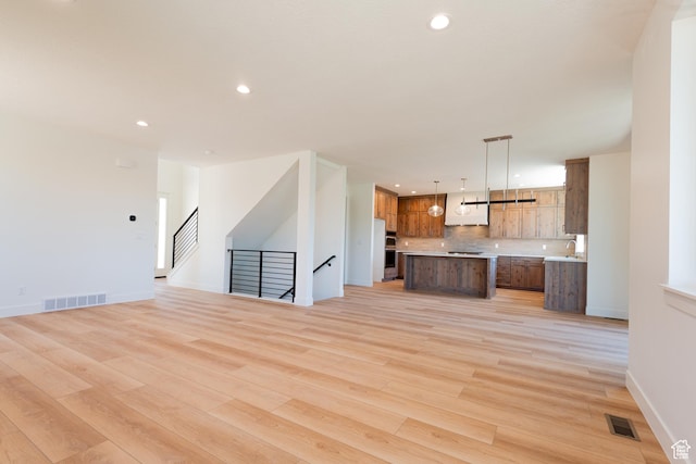 1699 N Siena Cir Unit 5, Pleasant Grove, UT 84062 - unfurnished living room with light wood-type flooring and recessed lighting