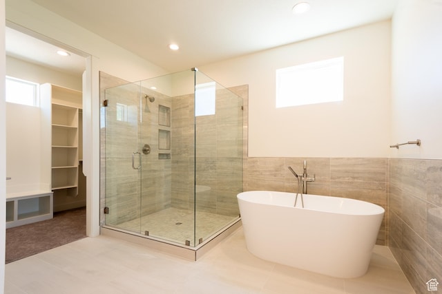 1699 N Siena Cir Unit 5, Pleasant Grove, UT 84062 - bathroom featuring a shower stall, a soaking tub, tile walls, recessed lighting, and a wainscoted wall