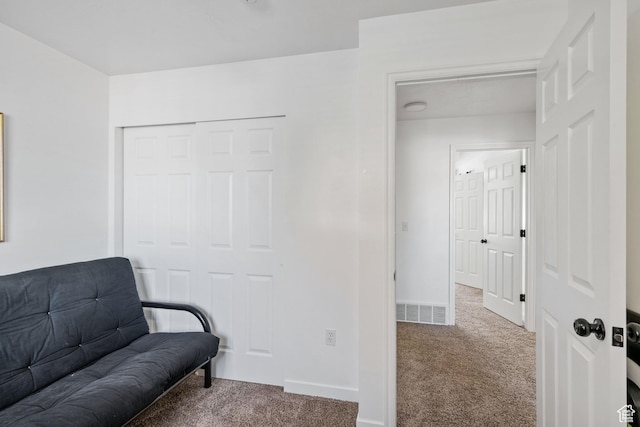 sitting room featuring carpet and baseboards