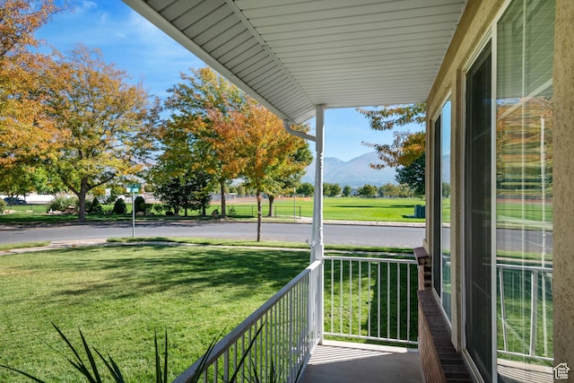 balcony with a porch and a mountain view