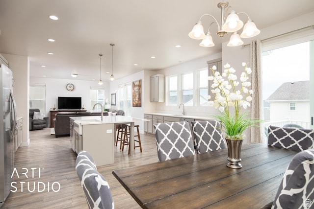 6637 W Terrace Sky Ln, West Jordan, UT 84081 - dining area featuring light wood-type flooring, recessed lighting, and a chandelier