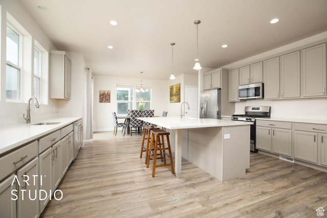 6637 W Terrace Sky Ln, West Jordan, UT 84081 - kitchen featuring stainless steel appliances, a sink, gray cabinets, light wood-style floors, and recessed lighting
