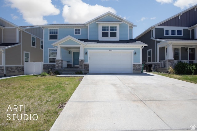 6637 W Terrace Sky Ln, West Jordan, UT 84081 - craftsman-style house with stone siding, concrete driveway, a garage, a front lawn, and covered porch