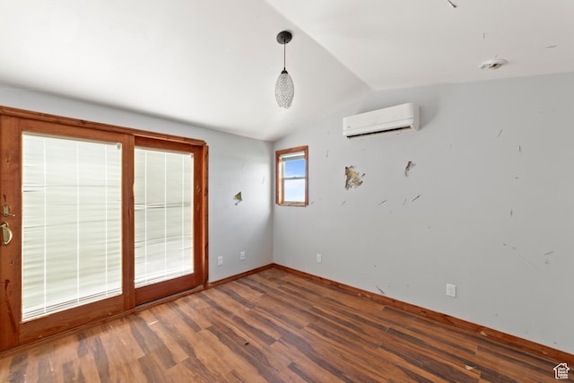 1 Pioneer Dr, La Sal, UT 84530 - empty room with an AC wall unit, wood finished floors, vaulted ceiling, and baseboards