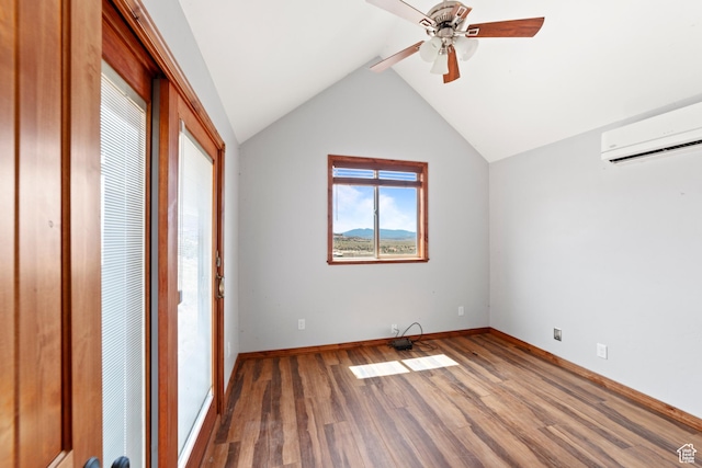 1 Pioneer Dr, La Sal, UT 84530 - unfurnished bedroom with an AC wall unit, wood finished floors, baseboards, vaulted ceiling, and a ceiling fan