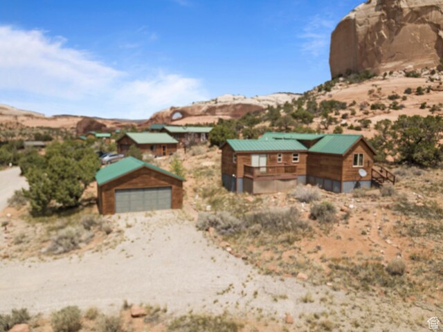 1 Pioneer Dr, La Sal, UT 84530 - view of front of property with a detached garage, a mountain view, an outdoor structure, and view of desert