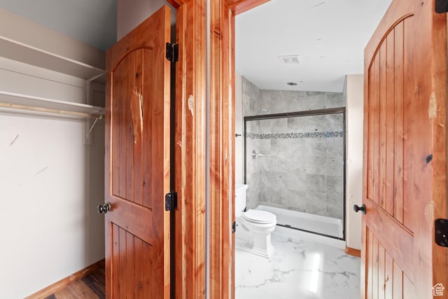 1 Pioneer Dr, La Sal, UT 84530 - full bath featuring a stall shower, toilet, marble finish flooring, and baseboards