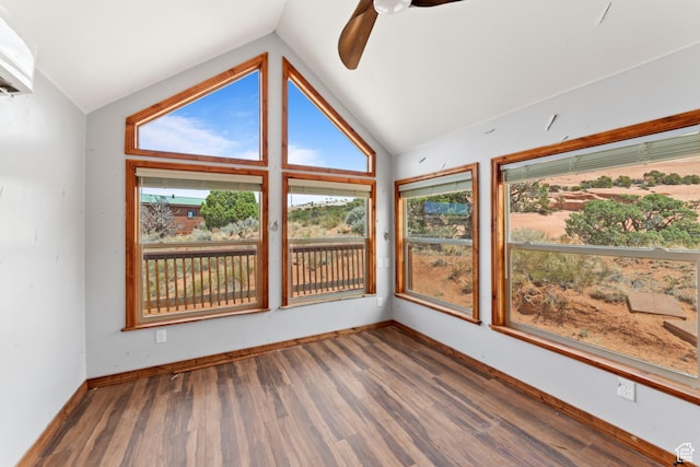 1 Pioneer Dr, La Sal, UT 84530 - unfurnished sunroom with vaulted ceiling, plenty of natural light, wood finished floors, and baseboards