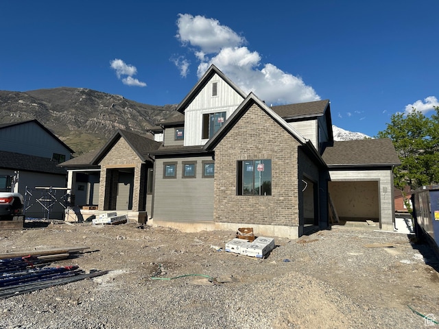1768 N Siena Cir Unit 12, Pleasant Grove, UT 84062 - view of front of home with an attached garage, a mountain view, board and batten siding, and brick siding