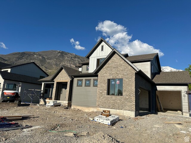 1768 N Siena Cir Unit 12, Pleasant Grove, UT 84062 - view of front of house featuring a mountain view, a garage, brick siding, and board and batten siding
